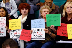 Residents hold signs during a hearing over a gas leak at the Southern California Gas Company's Aliso Canyon Storage Facility near Porter Ranch, in Los Angeles. (AP Photo/Richard Vogel)