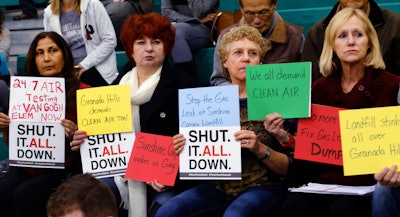 Residents hold signs during a hearing over a gas leak at the Southern California Gas Company's Aliso Canyon Storage Facility near Porter Ranch, in Los Angeles. (AP Photo/Richard Vogel)
