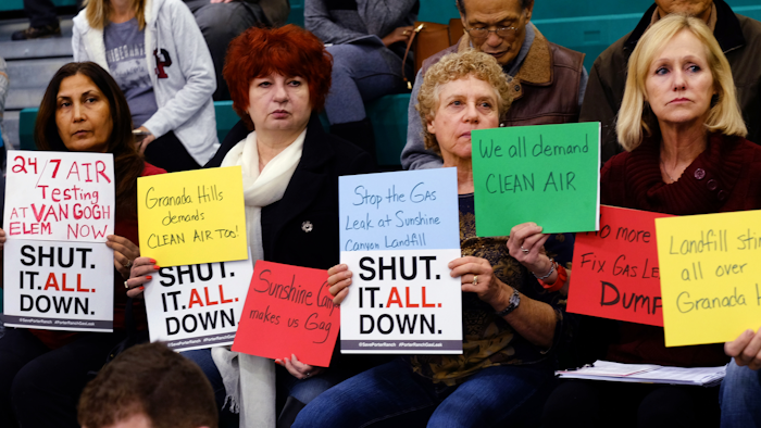 Residents hold signs during a hearing over a gas leak at the Southern California Gas Company's Aliso Canyon Storage Facility near Porter Ranch, in Los Angeles. (AP Photo/Richard Vogel)