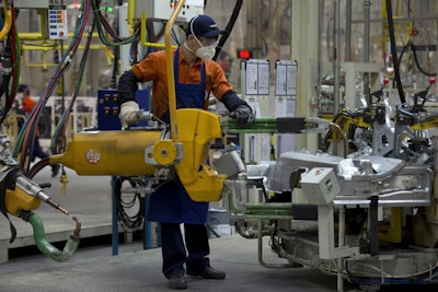 In this April 21, 2015 file photo, a worker performs welding on car part at a Volvo factory in Chengdu in southwestern China's Sichuan province. A survey says China's manufacturing outlook has slumped to its lowest level in more than four years, highlighting sluggish conditions in the world's second biggest economy. An index based on an official survey of factory purchasing managers declined to 49.0 in February from 49.4 in January in the seventh straight month of contraction. The index is now at its lowest level since Nov. 2011. (AP Photo/Ng Han Guan, File)