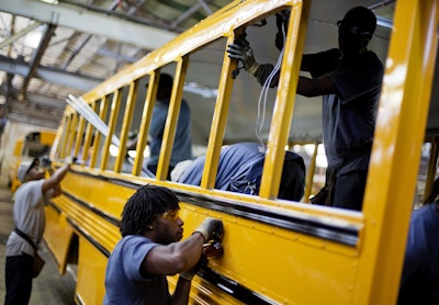 In this Friday, Sept. 18, 2015, photo, employees work on a school bus on the assembly line at Blue Bird Corporation's manufacturing facility, in Fort Valley, Ga. On Tuesday, March 1, 2016, the Institute for Supply Management, a trade group of purchasing managers, issues its index of manufacturing activity for February. (AP Photo/David Goldman)