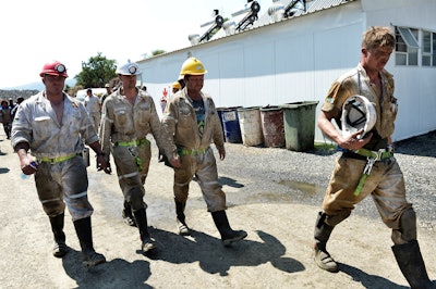 In this Saturday Feb. 13, 2016 file photo, search and rescue team members at the Lily Gold Mine near Barberton, South Africa. A spokesman for a collapsed gold mine in South Africa said on Tuesday March 8, 2016, the search has been suspended for the three people who have been trapped underground for more than a month because the ground is too unstable. (AP Photo)