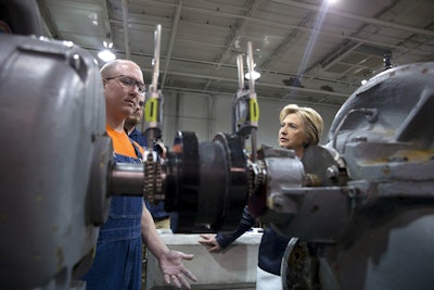 Before speaking at a campaign event Democratic presidential candidate Hillary Clinton talks with Joseph Rainwater, left, as she tours the pumps and motor section of the Nelson-Mulligan Carpenters’ Training Center in St. Louis, Saturday, March 12, 2016. (AP Photo/Carolyn Kaster)