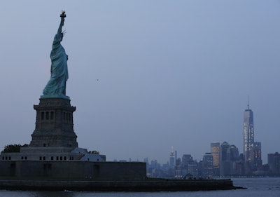 In this Tuesday, July 7, 2015, file photo, the Statue of Liberty stands in New York harbor with the New York City skyline in the background. On Tuesday, March 15, 2016, the Federal Reserve of New York releases its March survey of manufacturers. (AP Photo/Kathy Willens, File)