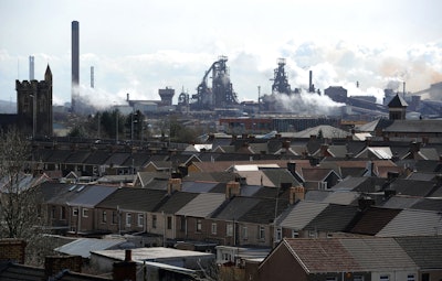 The Tata steel plant dominates the skyline over the roof tops of Port Talbot, Wales, Wednesday March 30, 2016. UK authorities say they will look at all viable options to keep the British steel industry at the heart of its manufacturing base after Tata Steel announced it may sell its UK assets. The sale could put thousands of jobs at risk. (Andrew Matthews/PA via AP)