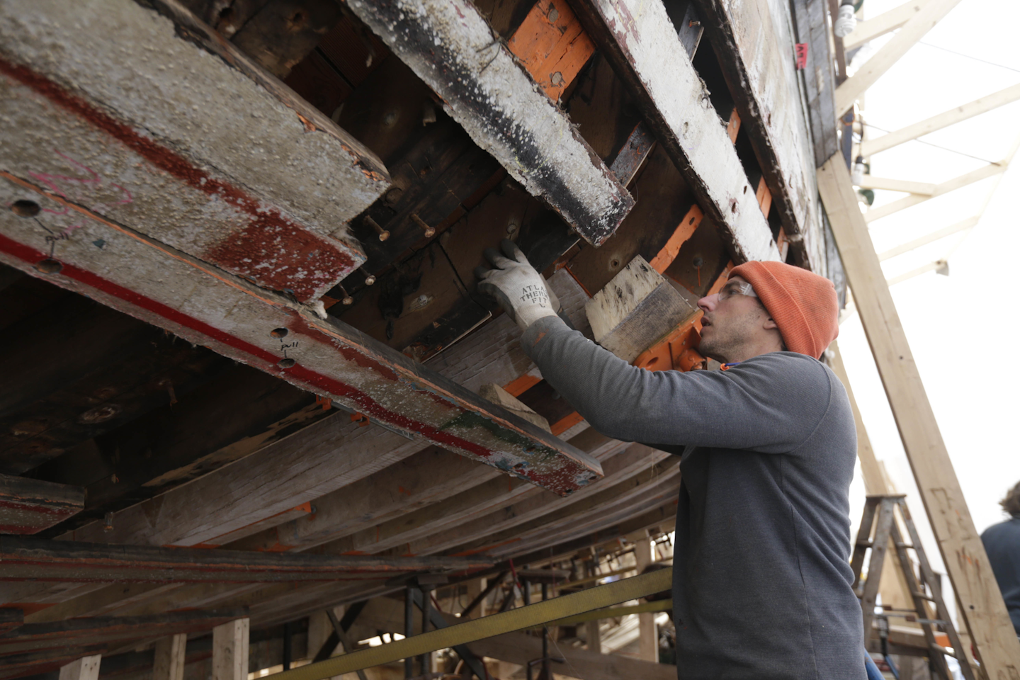 In this Wednesday, March 2, 2016 photo, Tom Kindling makes a pattern for a new futtock during restoration of the sloop Clearwater in Kingston, N.Y. (AP Photo/Mike Groll)