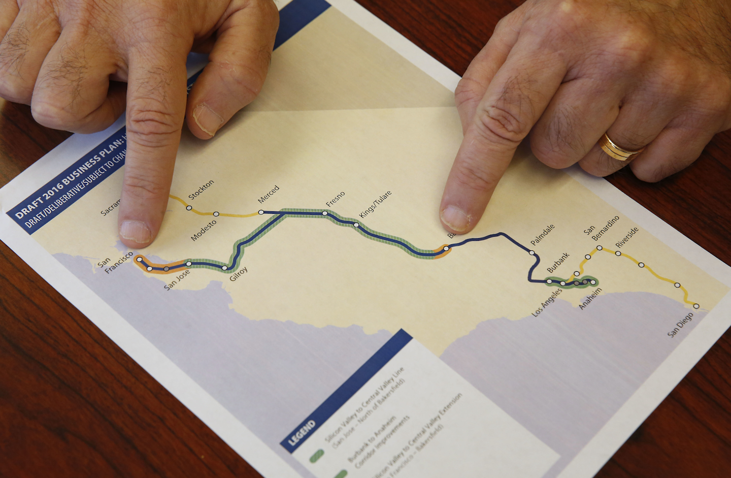 Dan Richard, chairman of the board that oversees the California High-Speed Rail Authority, gestures to a map showing the proposed initial construction of the bullet train in the revised business plan, Thursday, Feb. 18, 2016, in Sacramento, Calif. (AP Photo/Rich Pedroncelli)