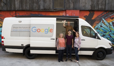 Google User Experience Researcher John Webb, background, Dawn Herman, left, Henry Liang, center, and Victoria Sosik pose for a photo with Google's User Experience van in New York. (AP Photo/Mary Altaffer)