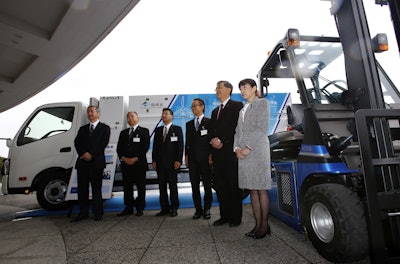 A Toyota fuel cell forklift, right, and a truck designed for hydrogen fueling station and carrying hydrogen, background, are displayed in Yokohama, near Tokyo, after a press event for Hydrogen Supply Chain Demonstration Project Monday, March 14, 2016. (AP Photo/Shizuo Kambayashi)