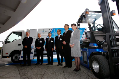 A Toyota fuel cell forklift, right, and a truck designed for hydrogen fueling station and carrying hydrogen, background, are displayed in Yokohama, near Tokyo, after a press event for Hydrogen Supply Chain Demonstration Project Monday, March 14, 2016. (AP Photo/Shizuo Kambayashi)