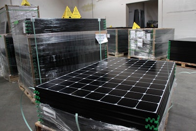 The latest generation of SunPower solar panels are stacked in Positive Energy Solar's warehouse in Albuquerque, N.M. (AP Photo/Susan Montoya Bryan)