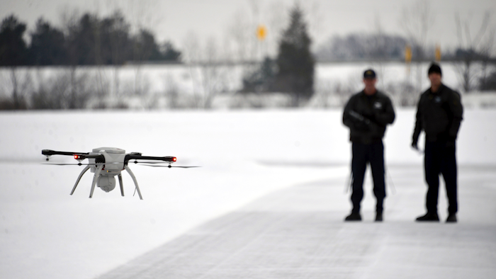 Michigan State Police Sgt. Matt Rogers and Trooper Don Zinz bring the Aeryon SkyRanger in for a landing during a demonstration of the new Unmanned Aircraft System at the State Police training track in Dimondale, Mich. (Dale G. Young/Detroit News via AP, File)