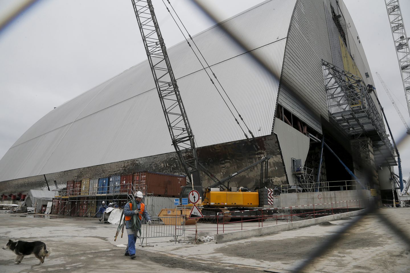 In this photo taken Wednesday, March 23, 2016 workers build an arch-shape confinement that will be moved on rails over the sarcophagus and reactor building damaged by explosion, at the Chernobyl nuclear power plant in Chernobyl, Ukraine. Thirty years after the world’s worst nuclear accident, the Chernobyl nuclear power plant is surrounded by both a hushed desolation and clangorous activity, the sense of a ruined past and a difficult future. (AP Photo/Efrem Lukatsky)