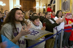 Supporters of a bill to raise California's minimum wage, celebrate outside the state Senate Chamber after the measure was approved by the Senate Thursday, March 31, 2016, in Sacramento, Calif. The bill, SB3, that will gradually raise California's minimum wage to a nation leading $15 an hour by 2022, was approved by both houses of the Legislature and sent to Gov. Jerry Brown who said he will sign it. (AP Photo/Rich Pedroncelli)
