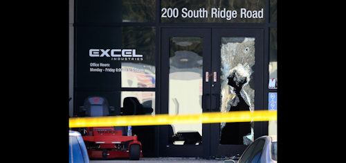 FILE - In this Feb. 26, 2016 file photo, shattered glass and bullet holes are seen at the front door of Excel Industries in Hesston, Kan. A police chief who rushed without backup into a Kansas lawnmower factory amid a shooting rampage fatally shot the gunman about five minutes after he arrived. That's according to a timeline and recordings of 911 calls that authorities released Thursday, March 10, 2016. (AP Photo/Orlin Wagner, File)