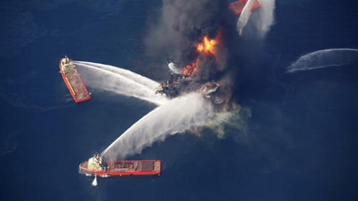 In this April 21, 2010, file photo, the Deepwater Horizon oil rig burns in the Gulf of Mexico following an explosion that killed 11 workers and caused the worst offshore oil spill in the nation's history. (AP Photo/Gerald Herbert)