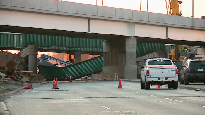 Workers were in lifts trying to remove the beam under Interstate 90 when it collapsed on them around 3 a.m. (WGN-TV via AP)