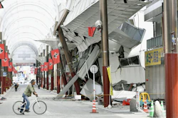 A cyclist looks at a shopping arcade destroyed by an earthquake in Kumamoto city, southern Japan. The powerful earthquake struck southwestern Japan early Saturday, barely 24 hours after a smaller quake hit the same region. (Kyodo News via AP)