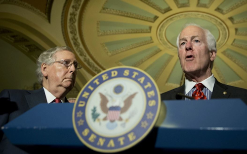 Senate Majority Leader Mitch McConnell listens at left as Senate Majority Whip John Cornyn speaks to reporters on Capitol Hill in Washington. (AP Photo/Manuel Balce Ceneta)