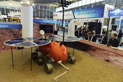 Visitors to the 16th China International Industry Fair (CIIF) look at a prototype of what a Chinese Mars rover would look like in Shanghai, China. (Chinatopix via AP)