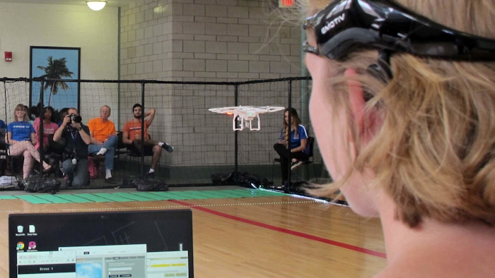 A University of Florida student uses a brain-controlled interface headset to fly a drone during a mind-controlled drone race in Gainesville, Fla. (AP Photo/Jason Dearen)