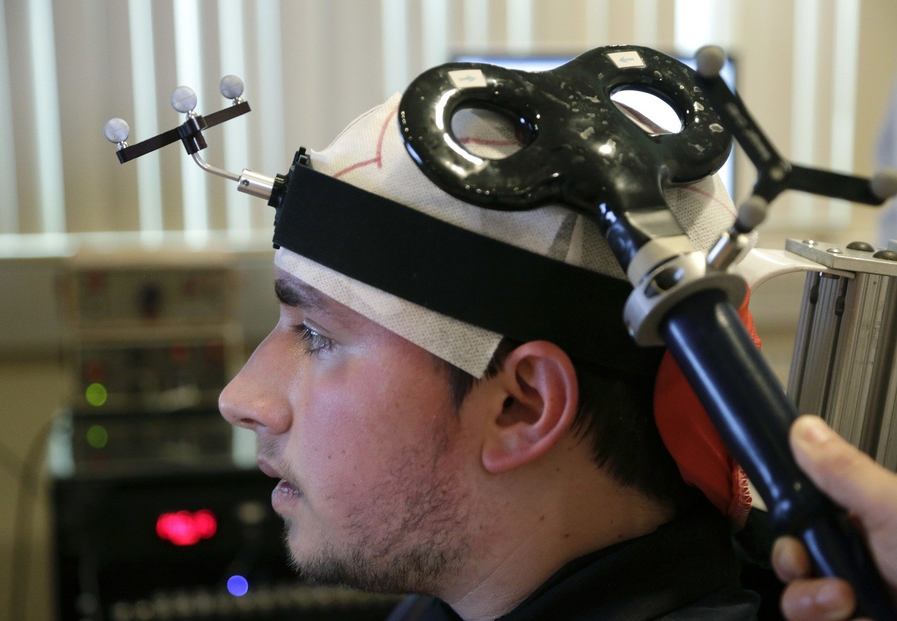 Richard Tursi, 19, undergoes therapy that uses a brain-controlled technology to help improve his motor functions at the Miami Project to Cure Paralysis at the University of Miami Miller School of Medicine in Miami. (AP Photo/Lynne Sladky)