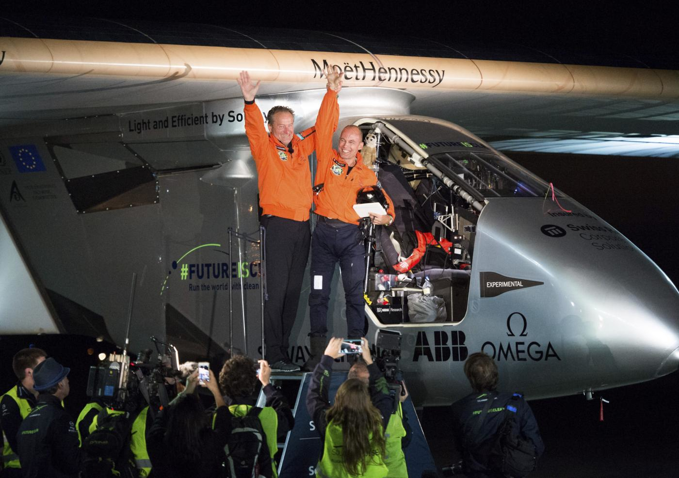 Solar Impulse 2 pilots Bertrand Piccard, right, and Andre Borschberg celebrate after Piccard landed their solar-powered plane at Moffett Field in Mountain View, Calif., on Saturday, April 23, 2016. (AP Photo)