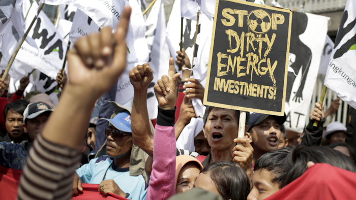 Protesters shout slogans during a rally calling for an end to the use of coal to fire power plants, outside the Japanese Embassy in Jakarta, Indonesia, Wednesday, May 11, 2016. Japan helped funded the construction of three coal-fired power plants in the country with nearly $1 billion in loans. (AP Photo/Dita Alangkara)