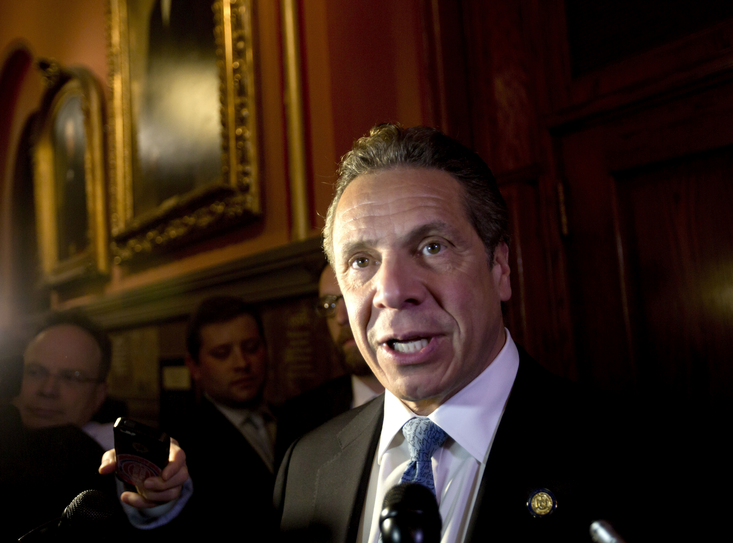 In this March 30, 2016, file photo, New York Gov. Andrew Cuomo talks to media members outside his office at the state Capitol in Albany, N.Y. (AP Photo/Mike Groll, File)