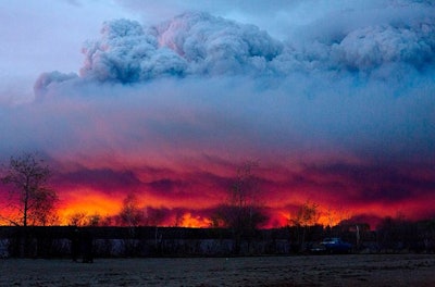 A wildfire moves toward the town of Anzac from Fort McMurray, Alberta in Canada on Wednesday May 4. (Jason Franson/The Canadian Press via AP)