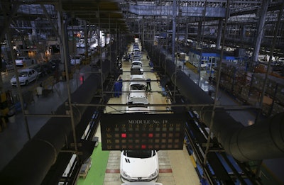 Iranian car workers assemble cars at the state-run Iran Khodro automobile manufacturing plant, just outside Tehran, Iran. (AP Photo/Vahid Salemi)