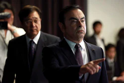 Nissan Motor Co. President and CEO Carlos Ghosn, right, and Mitsubishi Motors Corp. Chairman and CEO Osamu Masuko, left, walk in the venue of their joint press conference at the Nissan headquarters in Yokohama, near Tokyo. (AP Photo/Eugene Hoshiko)