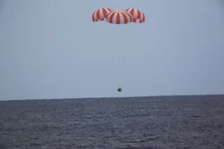 A SpaceX capsule containing science samples from NASA's one-year space station resident, approaches the Pacific Ocean, a few hundred miles off the Southern California coast, Wednesday, May 11, 2016. (SpaceX via AP)