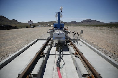 A recovery vehicle and test sled sit on a track after a test of a Hyperloop One propulsion system, Wednesday, May 11, 2016, in North Las Vegas. (AP Photo/John Locher)