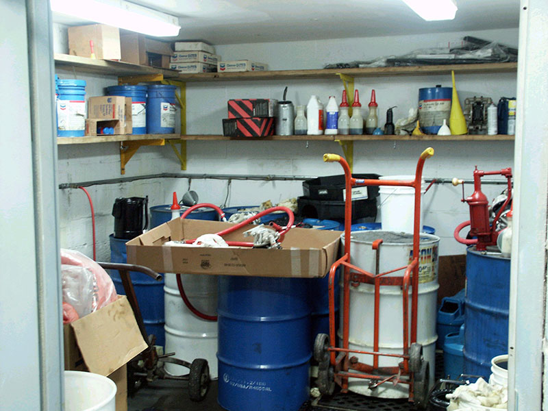 Original Lubricants Storeroom before improvement. Note: clutter, open pails, open funnels and open transfer containers. This is not a “World Class Lube Room”. This is a lubrication nightmare for every piece of equipment in the facility.