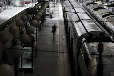 A man walks over an empty platform after a strike starts at the Gare du Nord train station, in Paris, Wednesday, June 1, 2016. Workers at the SNCF national rail authority, whose train service will be crucial to Euro 2016 spectators, are on an open-ended strike to protest their working conditions and a controversial government labor reform. (AP Photo/Markus Schreiber)