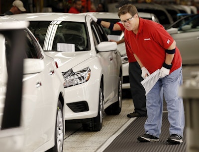 In this April 6, 2016, photograph, a technician conducts a final inspection before a finished Altima sedan is rolled out at the Nissan Canton Vehicle Assembly Plant in Canton, Miss. On Friday, June 24, 2016, the Commerce Department releases its May report on durable goods. (AP Photo/Rogelio V. Solis)