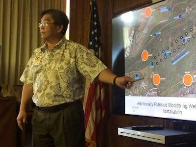 Honolulu Board of Water Supply chief engineer Ernest Lau points at a map during a meeting in Honolulu, Monday, July 27, 2016 to show where the Navy plans to build wells to monitor potential contamination from giant military fuel storage tanks. The U.S. Environmental Protection Agency told Honolulu water utility officials it approved three out of four new wells the Navy plans to build to help monitor the threat of leaks from the tanks near Pearl Harbor. (AP Photo/Audrey McAvoy)