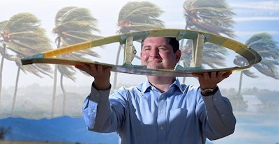 Todd Griffith displays a cross-section of a 50-meter blade. (Image courtesy of Randy Montoya, Sandia Labs)