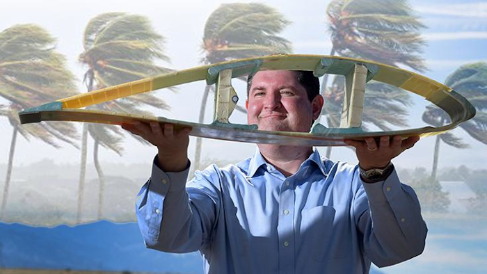 Todd Griffith displays a cross-section of a 50-meter blade. (Image courtesy of Randy Montoya, Sandia Labs)