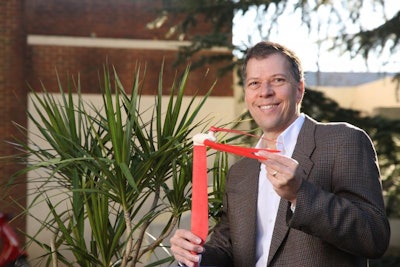 Eric Loth poses with a model of the SUMR wind turbine. (Image courtesy of the University of Virginia School of Engineering and Applied Science.)