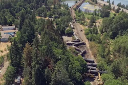 This video image taken from a drone shows an aerial view of crumpled oil tankers lying beside the railroad tracks after a fiery train derailment on June 3 prompted evacuations from the tiny Columbia River Gorge town about 70 miles east of Portland, on Monday, June 6. (Brent Foster via AP)