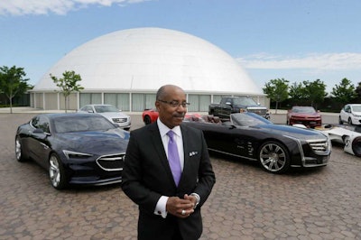 Ed Welburn, head of global design for General Motors, stands next to company concepts and production vehicles on the grounds of the company's Technical Center in Warren, Mich. (AP Photo/Carlos Osorio)