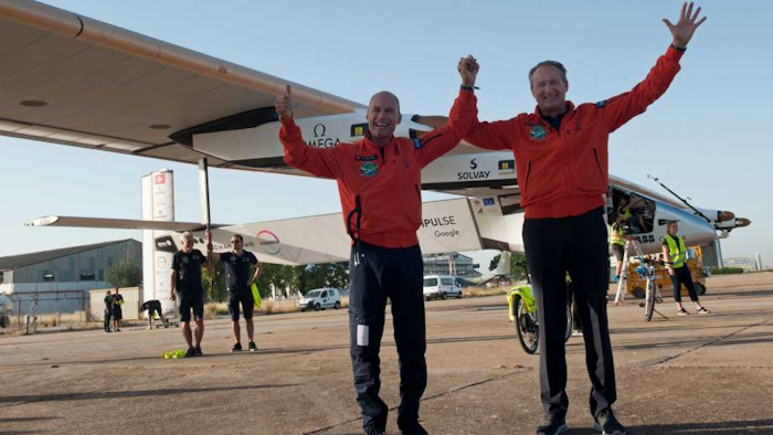 Pilots Bertrand Piccard, left and Andre Borschberg, right, celebrate the landing of the solar-powered plane at San Pablo airport in Seville, Spain on Thursday, June 23, 2016. (AP Photo/Laura Leon)