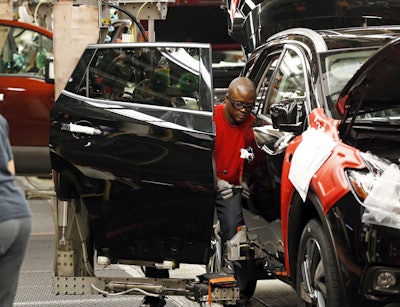 In this April 6, 2016, photograph, a technician works on a door assembly for a Nissan Altima on the line at the Nissan Canton Vehicle Assembly Plant in Canton, Miss. On Tuesday, July 5, 2016, the Commerce Department reports on U.S. factory orders for May. (AP Photo/Rogelio V. Solis)