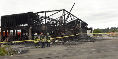 A massive fire that burned through a city block in downtown Olympia destroyed a 100-year-old warehouse in the 200 block of Adams Street in Olympia, Wash., Tuesday, July 5, 2016. Fire crews from Olympia, Lacey and McLane Fire Departments responded with no reported injuries. (Steve Bloom/The Olympian via AP)