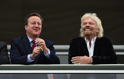 Britain's Prime Minister David Cameron, left, and Virgin boss Richard Branson at the Farnborough International Airshow in Farnorough, south England, Monday July 11, 2016. (Andrew Matthews / PA via AP)