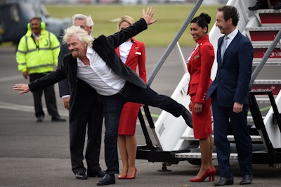 Virgin boss Richard Branson with Virgin Atlantic staff after they arrive aboard a new Airbus A350 at the Farnborough International Airshow in Farnorough, south England, Monday July 11, 2016. (Andrew Matthews / PA via AP)