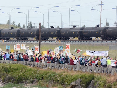 Anti-oil protestors walk past the Tesoro refinery rail yard in Anacortes, Wash. (Scott Terrell/Skagit Valley Herald via AP, File)