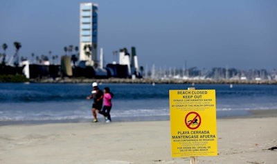 Long Beach officials estimate that more than 100,000 gallons of sewage reached the city, and its ocean waters will be closed until testing shows it's safe. (Gary Coronado/Los Angeles Times via AP)